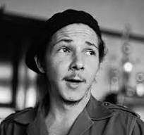 Small black-and-white close-up portrait of a young man in a beret and uniform