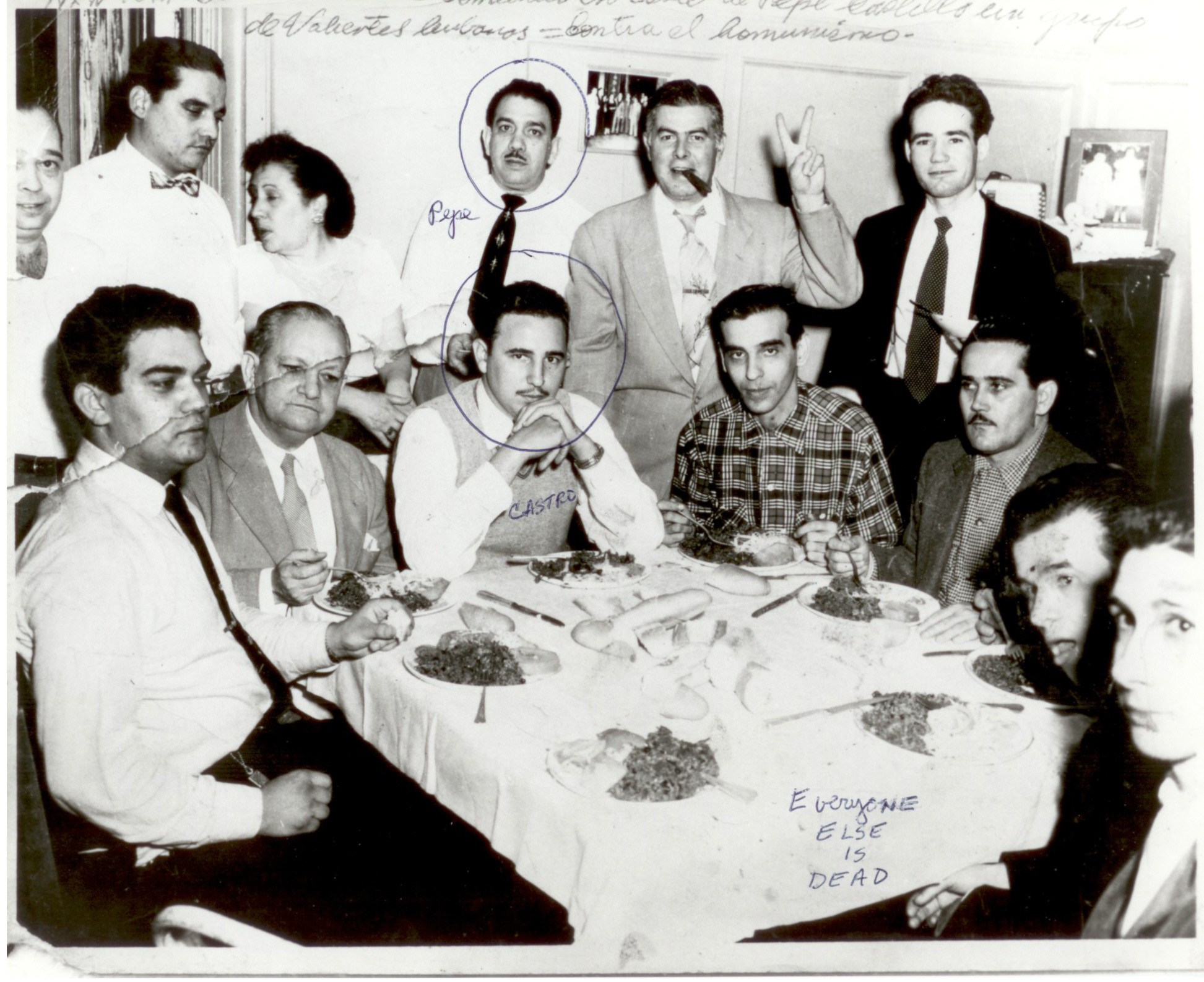 The same dinner photograph with two heads circled in blue ink and handwriting at the lower right