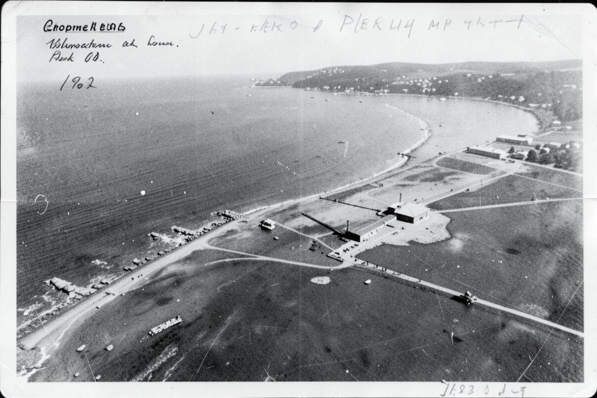Aerial reconnaissance photograph of a coastline and installation